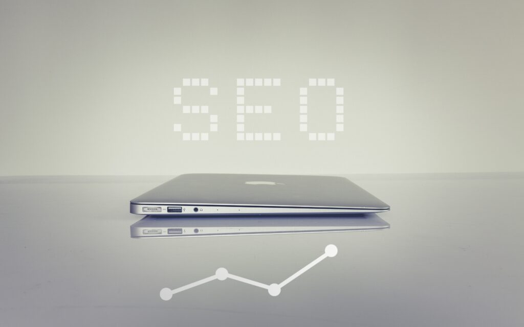 Image of SEO writen next to a laptop